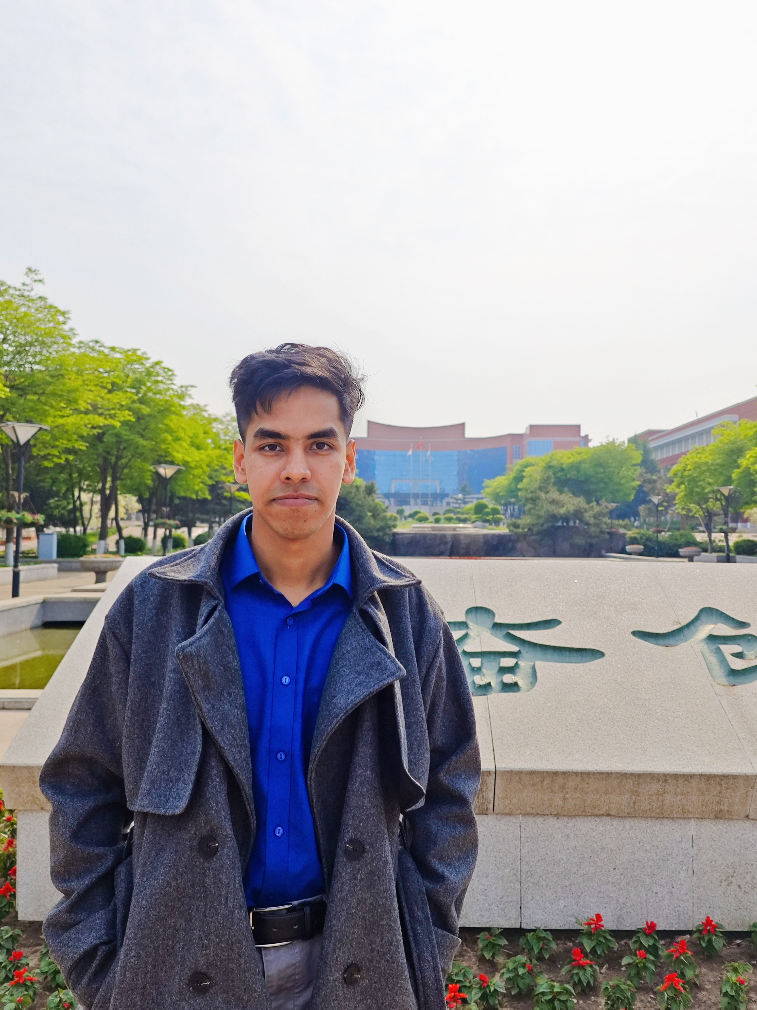Portrait of Kamrul Islam, a professional web designer with short hair wearing formal attire